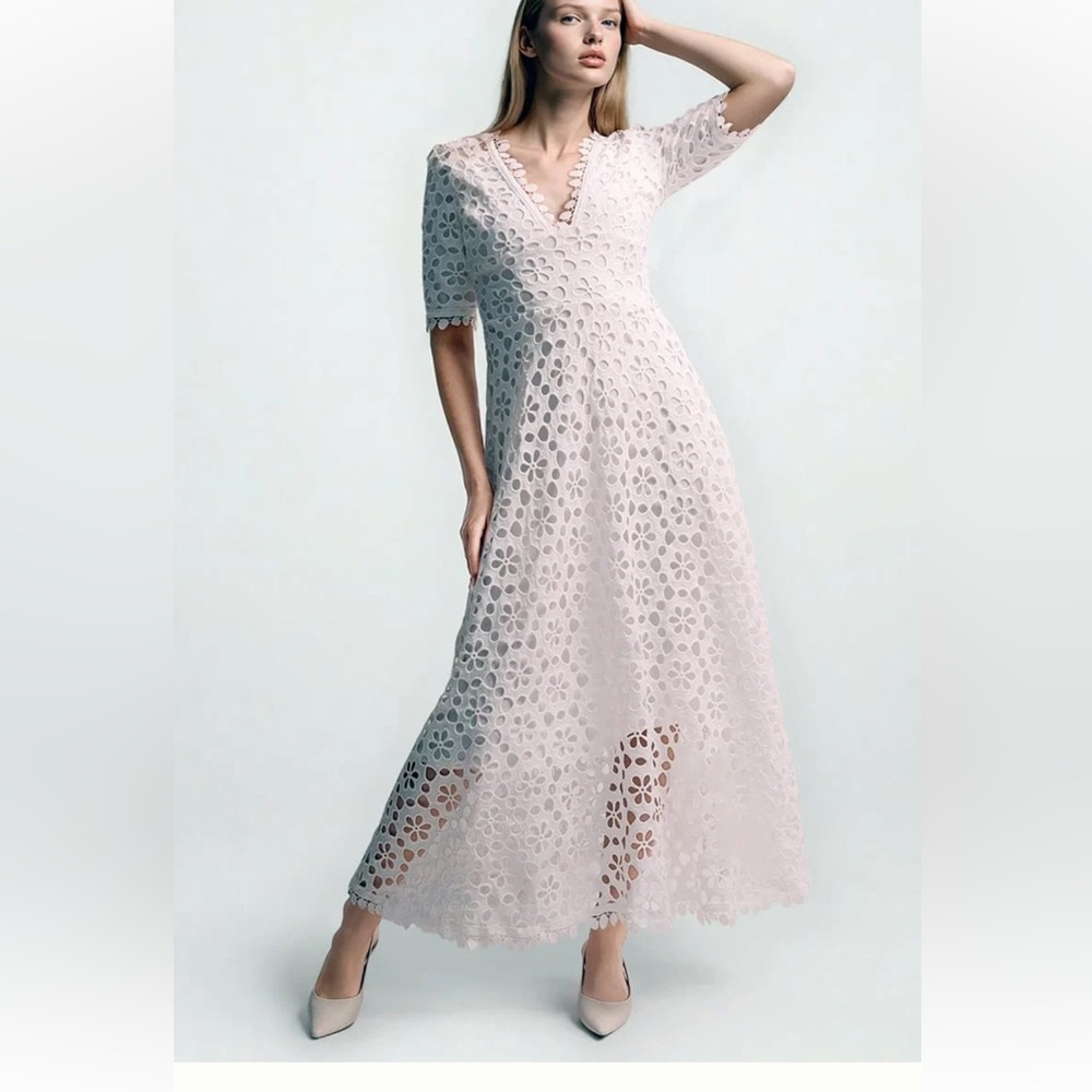 White lace embroidered A line dress with sleeves.